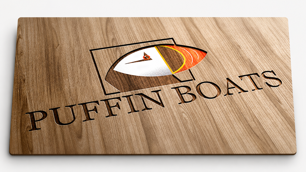 Puffin Boats logo engraved in wood.
